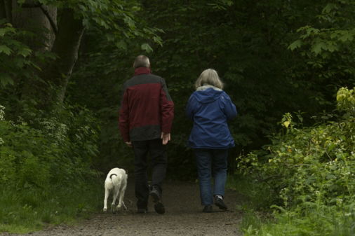 man in red jacket standing beside woman in blue jacket