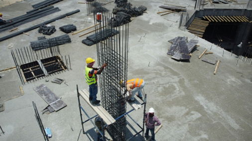 a group of men standing on top of a construction site